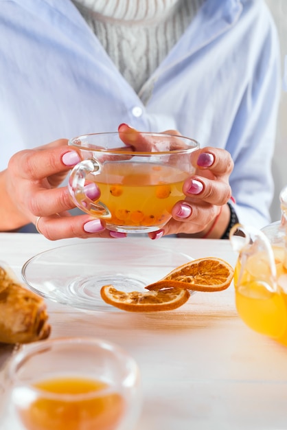 Female hands holding hot cup of tea