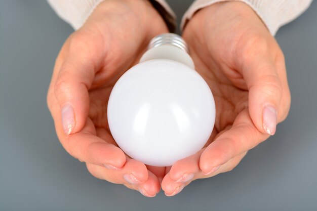 Female hands holding a led light bulb