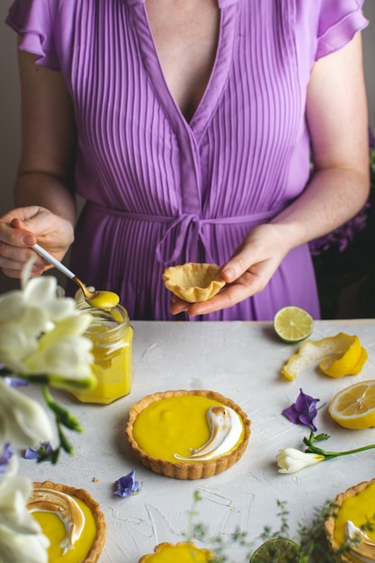 Female hands holding Lemon meringue tart