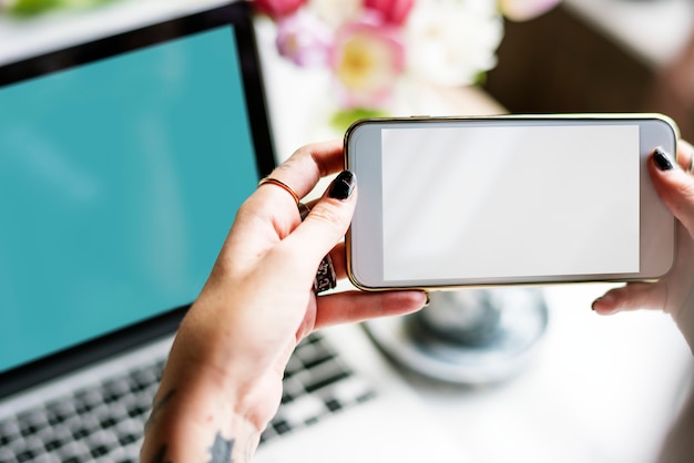 Female hands holding mobile phone with a black screen