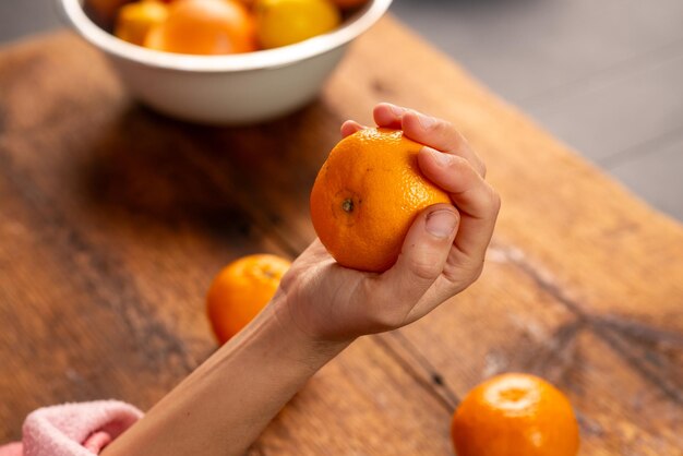 female hands holding oranges natural shot