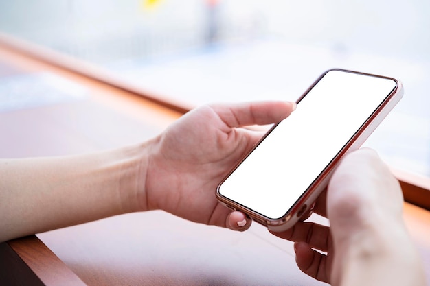 Female hands holding phone with isolated screen at outdoor