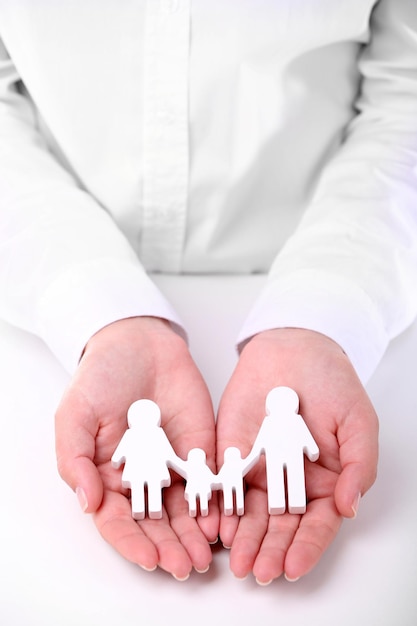 Photo female hands holding toy family closeup