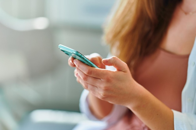 Female hands holds phone