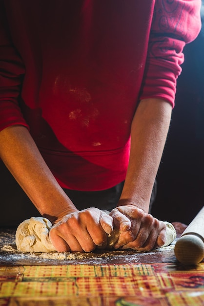Female hands knead the dough