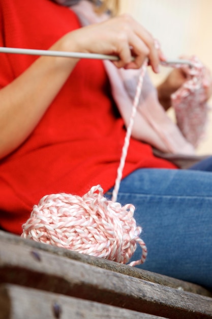 Female hands knitting sweater