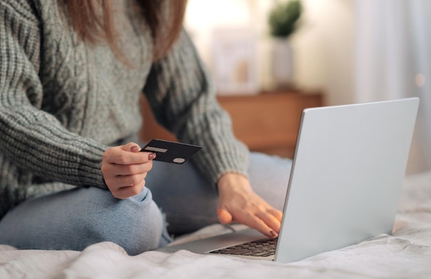 Female hands on the laptop with credit card Christmas online shopping sales