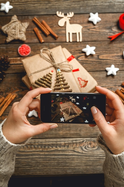 Female hands makes a photo of Christmas Accessories