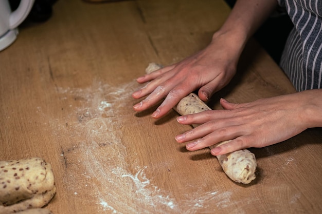 Photo female hands making a homemade baguette from whole grain flour healthy food