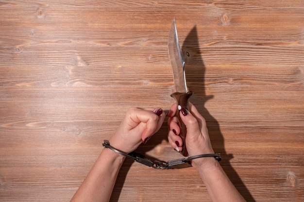 female hands in metal black handcuffs