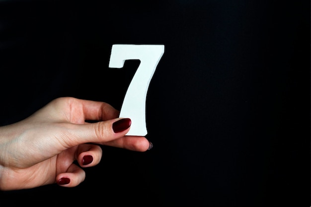 Photo to female hands the number seven