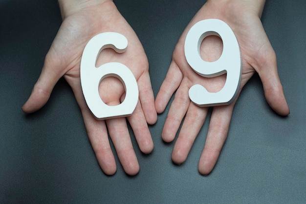 Photo to female hands the number sixtynine