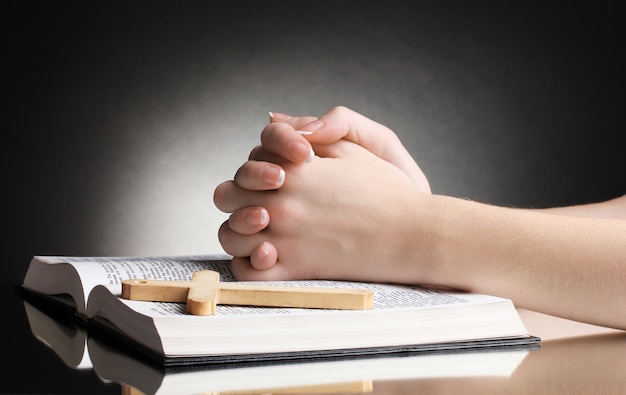 Female hands on open russian holy bible