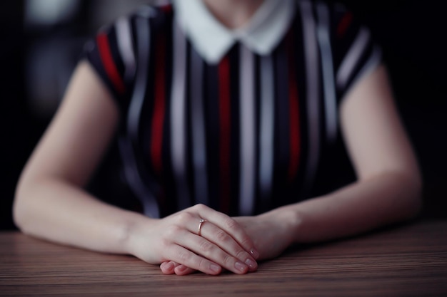 female hands sitting at the table waiting