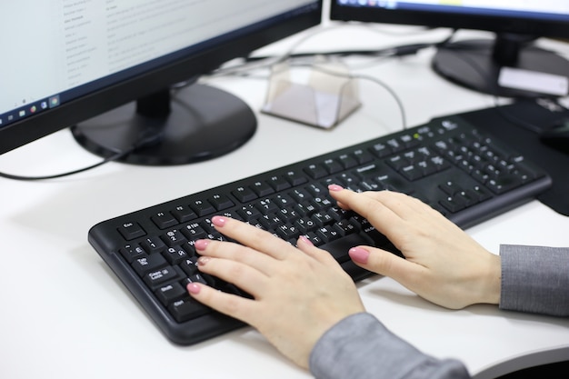 Female hands typing on computer