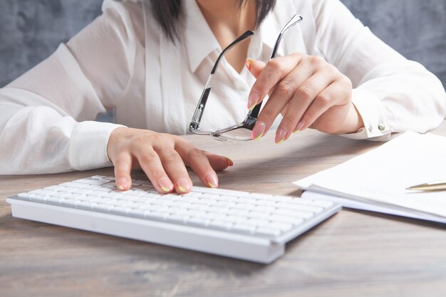 Female hands typing on the keyboard. optical glasses