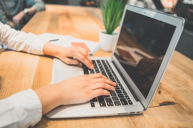 The female hands typing on the keyboard