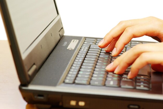 Female hands typing on laptop keyboard