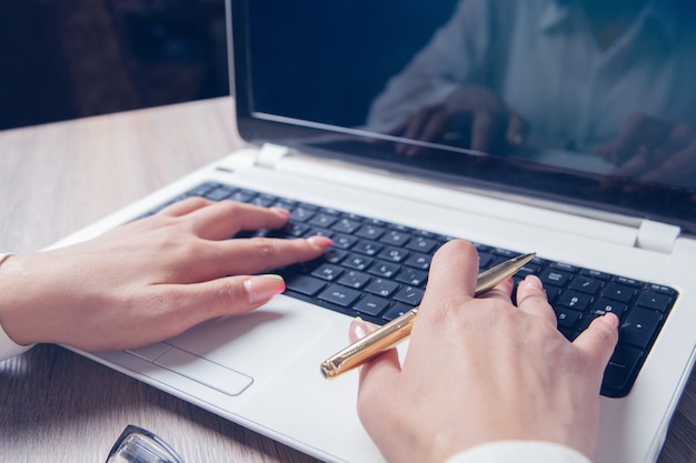 Female hands typing on laptop