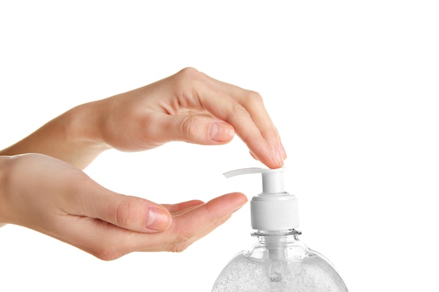 Female hands using liquid soap isolated on white