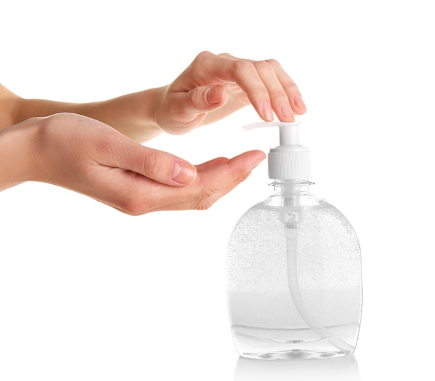 Female hands using liquid soap isolated on white