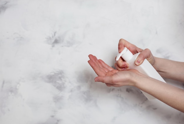 Female hands using liquid soap