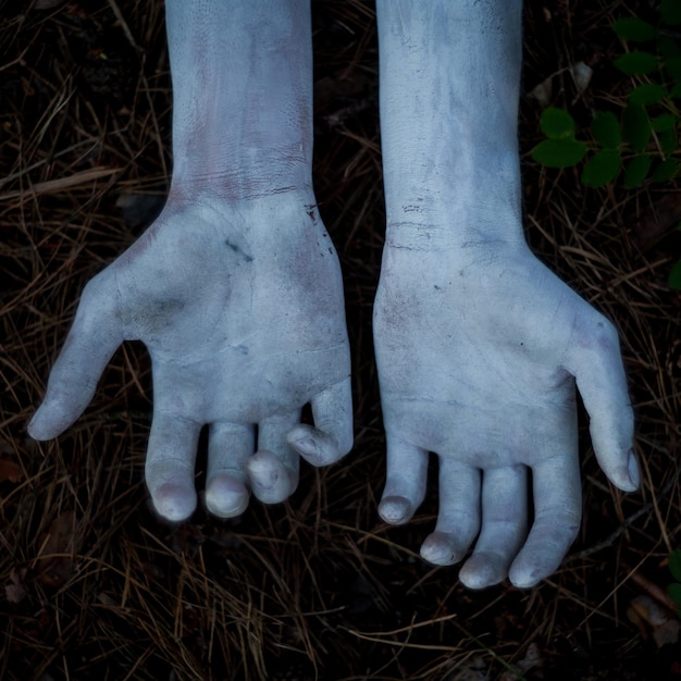 Female hands in white paint Female hands in white paint on a dark background