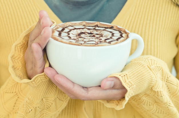 Female hands with coffee cup