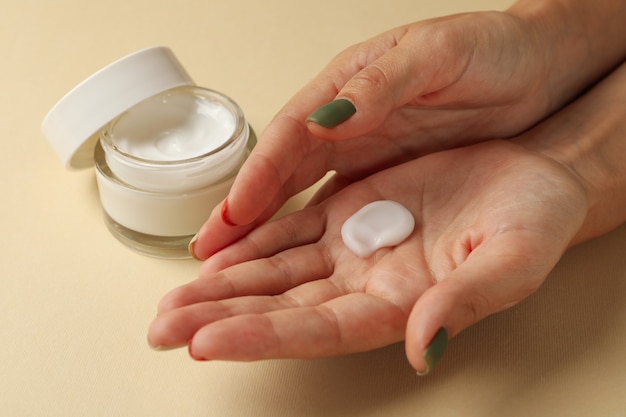 Female hands with cosmetic cream isolated