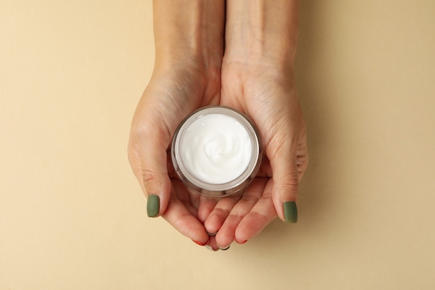 Photo female hands with cosmetic cream isolated