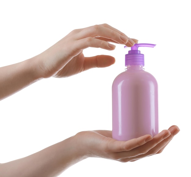 Female hands with cosmetics bottle isolated on white