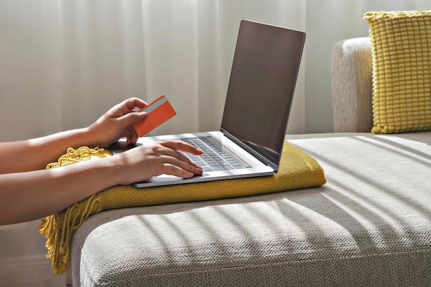 Female hands with credit card using laptop during online shopping Black Friday and Cyber Monday concept