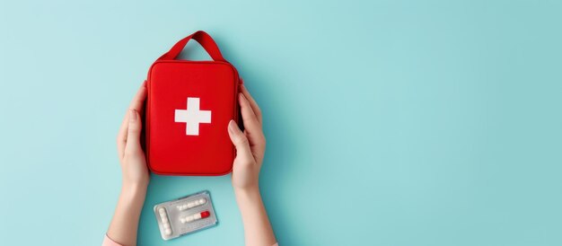 Female hands with first aid kit on light background with space for text