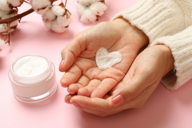 Female hands with heart shaped cream