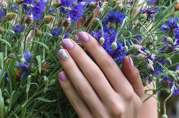 female hands with lilac nail design