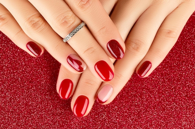 Female hands with manicure on red background