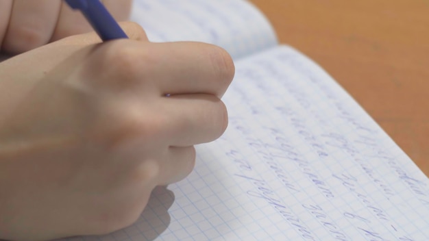 Female hands with pen writing on notebook