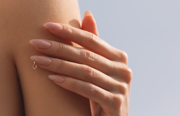 Female hands with pink nail design. Pink nail polish manicured hands.