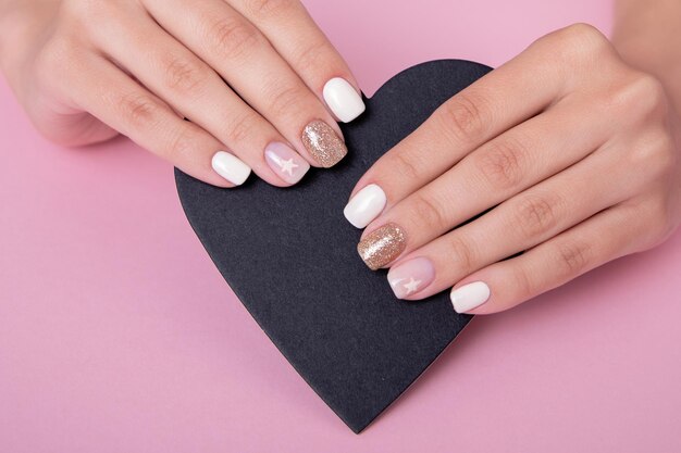 Female hands with romantic manicure nails, white gel polish