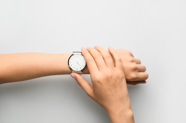 Female hands with stylish wrist watch isolated