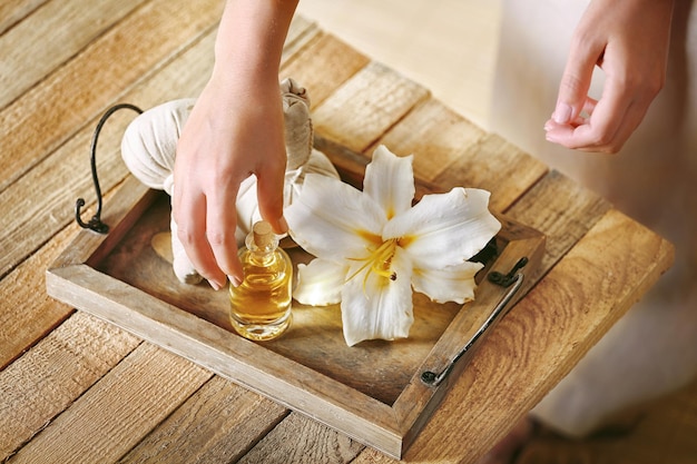 Female hands with tray of spa products at spa salon