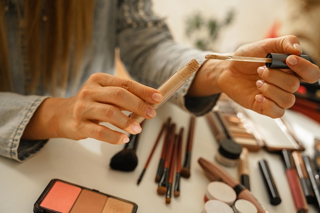 Female hands with tube of liquid concealer