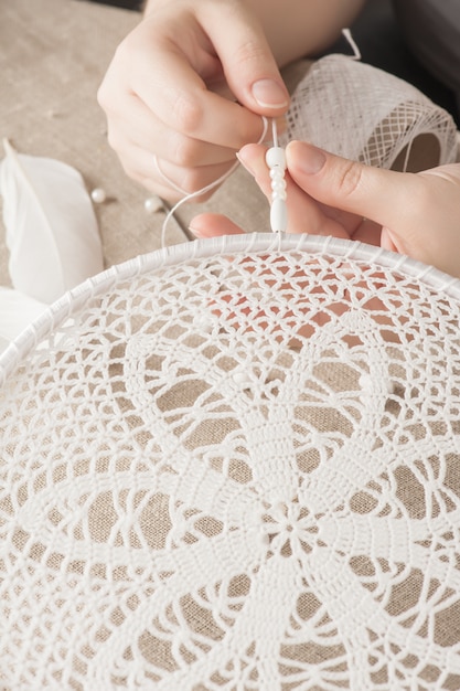 Female hands with white dream catcher