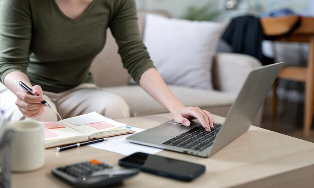 Female Hands Working On Laptop and writing note work from home