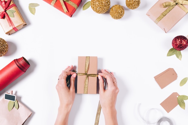 Female hands wrapping a gift