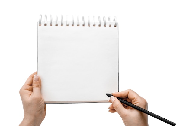 Mani femminili che scrivono in un taccuino mockup isolato su sfondo bianco vista dall'alto foto di mani femminili con matita nera che scrivono in pianificatore a spirale