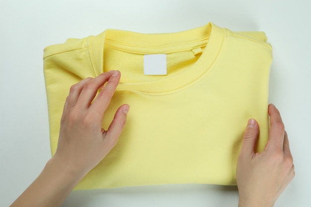 Female hands and yellow sweatshirt, top view