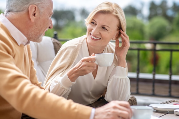 Female having a conversation with her male spouse at breakfast