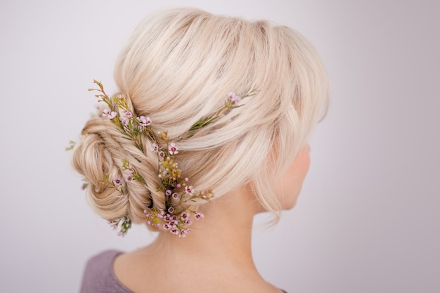 Female head back view. Make an elegant hairstyle with petals