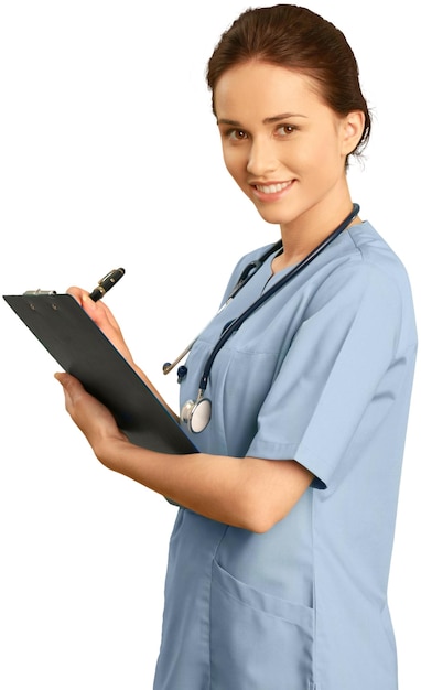 Female healthcare practitioner wearing scrubs and holding a clipboard